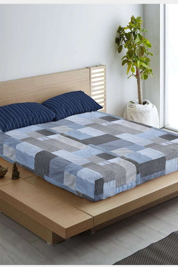 Eco-friendly patchwork bedsheet in blue and grey tones, made from upcycled textiles by Bunko Junko. Perfect for adding a sustainable and stylish touch to your bedroom decor