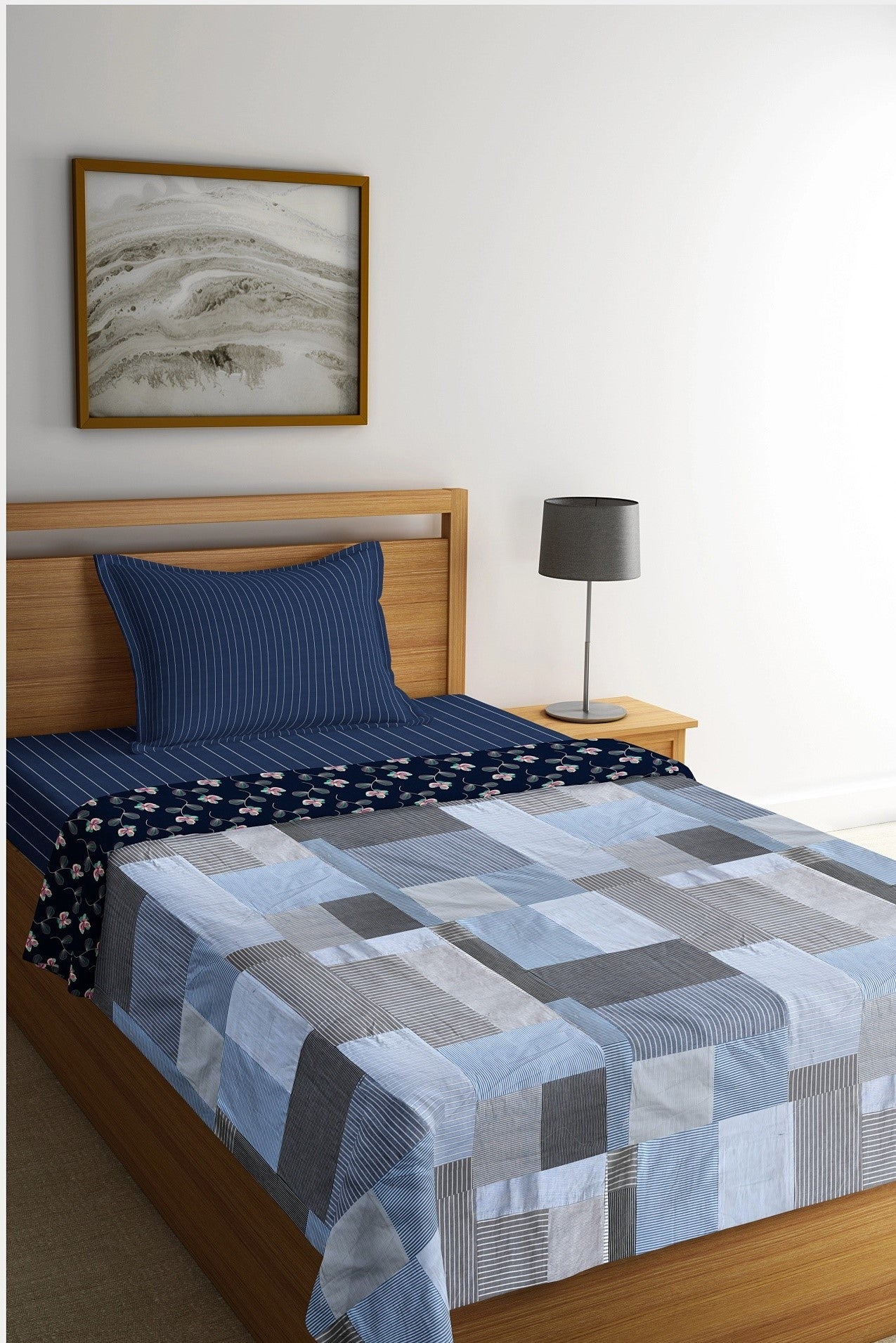 Eco-friendly patchwork bedsheet in blue and grey tones, made from upcycled textiles by Bunko Junko. Perfect for adding a sustainable and stylish touch to your bedroom decor