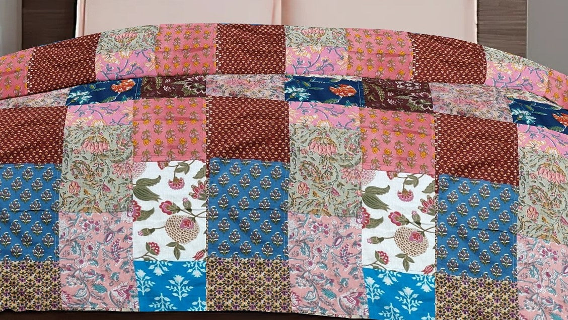 Colorful ethnic print patchwork bed quilt by Bunko Junko, showcasing vibrant and artistic designs with a blend of ethnic patterns. Ideal for adding a unique touch to your bedroom decor.