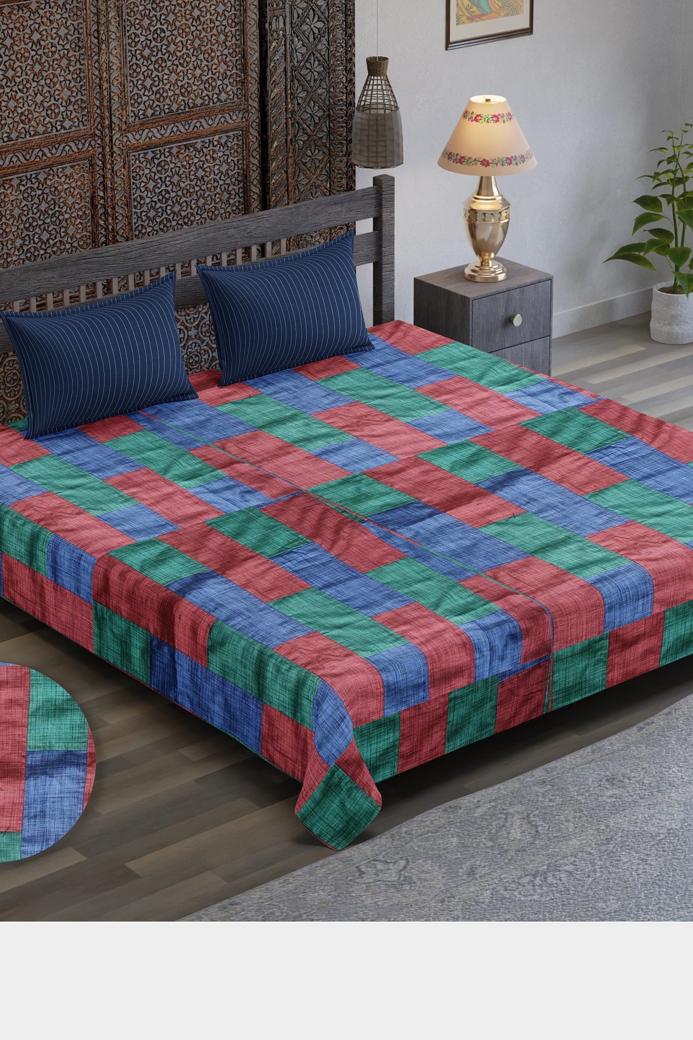A Tri-Color Tapestry Bedspread featuring a vibrant patchwork of red, blue, and green upcycled textiles, blending artistic design with eco-friendly craftsmanship.