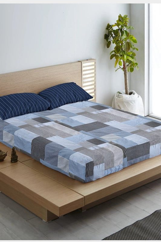 Eco-friendly patchwork bedsheet in blue and grey tones, made from upcycled textiles by Bunko Junko. Perfect for adding a sustainable and stylish touch to your bedroom decor
