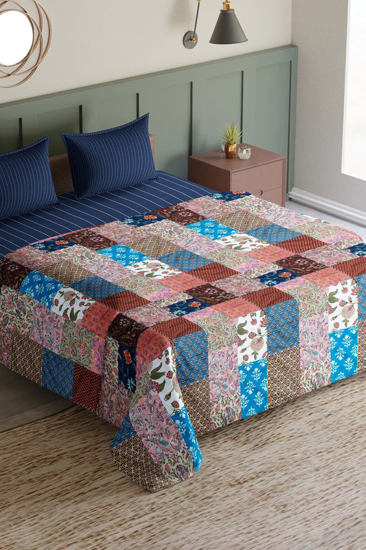 Colorful ethnic print patchwork bed quilt by Bunko Junko, showcasing vibrant and artistic designs with a blend of ethnic patterns. Ideal for adding a unique touch to your bedroom decor.