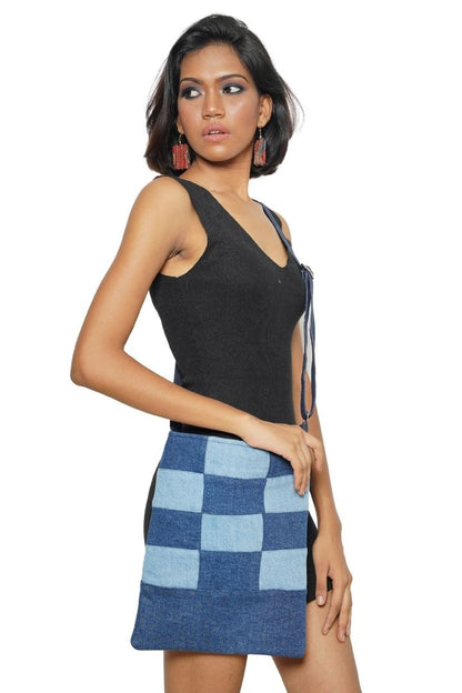 Patchwork Denim Sling by Bunko Junko: A trendy, upcycled denim sling bag featuring a unique patchwork pattern.