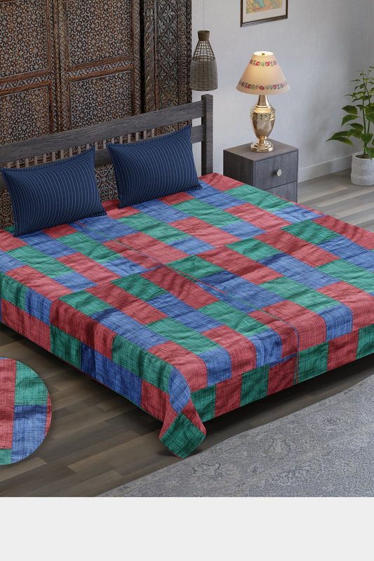  A Tri-Color Tapestry Bedspread featuring a vibrant patchwork of red, blue, and green upcycled textiles, blending artistic design with eco-friendly craftsmanship.