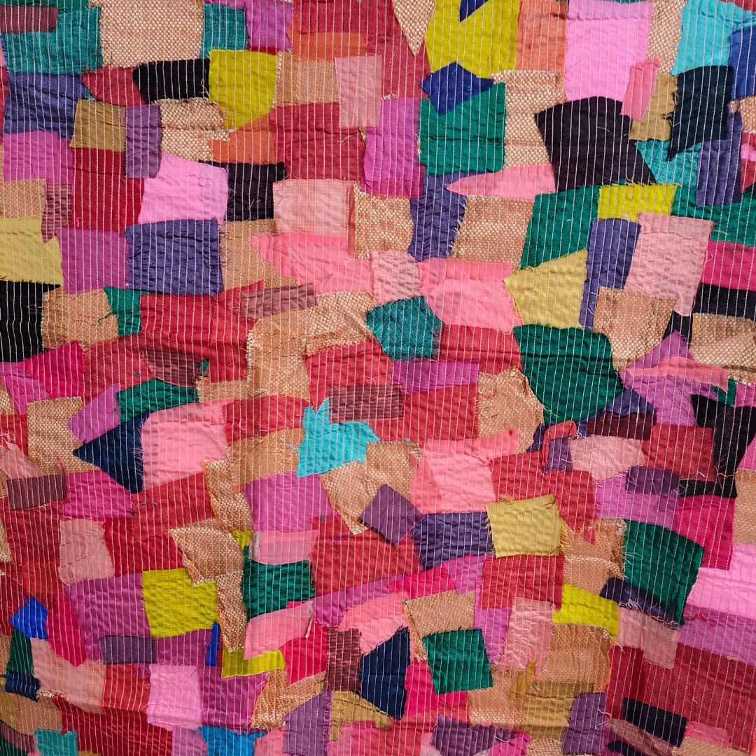 Colorful scrap fabric panel featuring an array of patterns and textures, emphasizing unique and sustainable design.